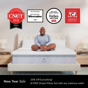 A person sits cross-legged and smiling on a bed with the HELIX Plus Mattress in a modern bedroom featuring wooden furniture. Logos for CNET, Wirecutter, Forbes Vetted, and ACA awards are above. A banner announces "New Year Sale: 25% Off Everything & FREE Dream Pillow Set.