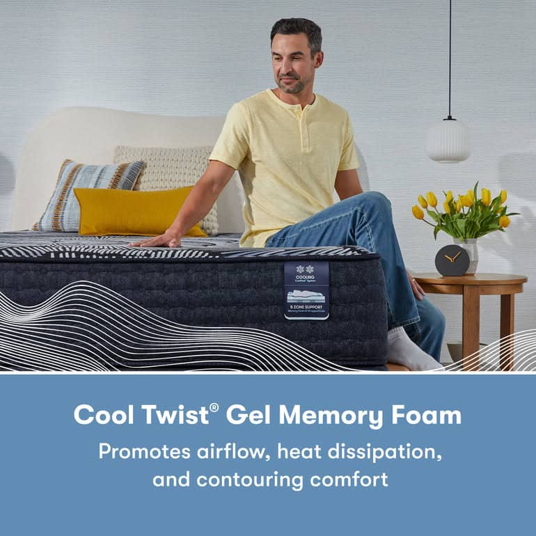 A man sits on the edge of a bed with a dark-colored mattress, gently touching it with his hand. The Serta Perfect Sleeper X Mattress: Prescott Medium Firm features a tag labeled "Cool Twist® Gel Memory Foam." In the background, there's a nightstand adorned with flowers and pillows. Text reads: "Promotes airflow, heat dissipation, and contouring comfort.