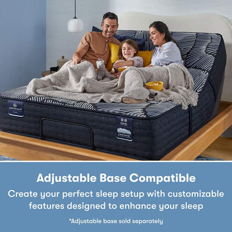A family of three, consisting of a man, a woman, and a child, are sitting up and smiling in bed with their Serta Perfect Sleeper X Hybrid Mattress: Aspen Firm. The bed features a striped comforter and they are covered by grey blankets. Text below the image reads: "Adjustable Base Compatible" with additional details about the Serta Perfect Sleeper.