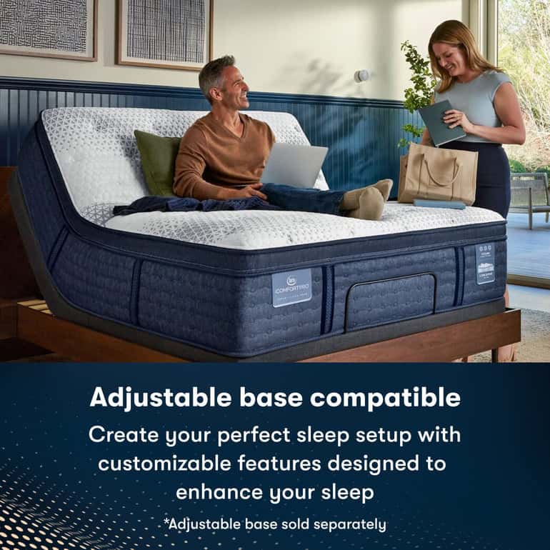A man sits on a Serta iComfortPro Mattress: Kingston Firm on a wooden bed frame, working with a laptop on his lap. A woman stands nearby, holding a mattress cover and smiling. Text below reads: "The Serta iComfortPro Mattress: Kingston Firm is adjustable base compatible. Create your perfect sleep setup with customizable features designed to enhance your rest. *Adjustable base sold separately.