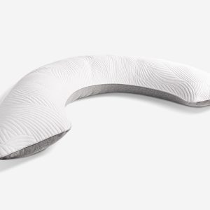 The Body Pillow is a crescent-shaped, white body pillow featuring a subtle leaf pattern stitched on the surface. The underside is composed of gray fabric. Curved to provide full-body support during sleep or lounging, it serves as an ideal sleep aid. It is placed against a plain white background.