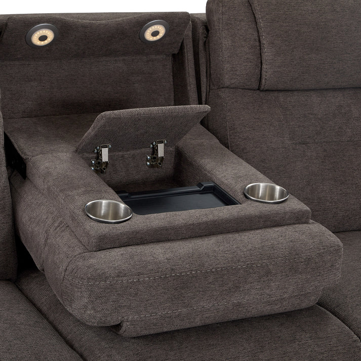 A close-up of the Zofa Umber Power Sleep Sofa shows its brown fabric and a fold-down center console with two cup holders and an open storage compartment with a hinged lid.