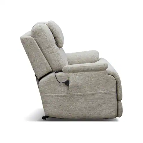 A side view of the Model 2 Plus Shell Exclusive recliner in light gray, featuring thickly cushioned seat, back, and armrests, with an electric remote attached.