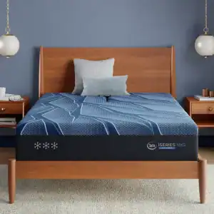 A modern wooden bed features a blue and black Serta iSeries NXG 3500 Hybrid — Medium mattress, two accent pillows, and matching nightstands with lamps, all set against a blue wall.