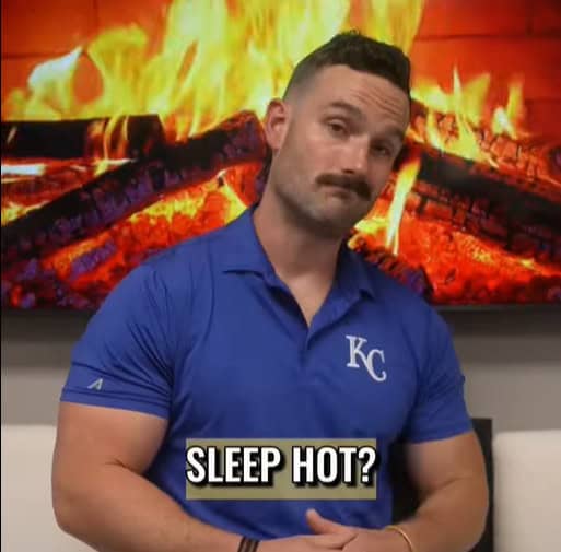 A man in a blue KC polo shirt stands in front of a burning fireplace, with the words "Sleep Hot or need to fix sleep heat?" written across the image.