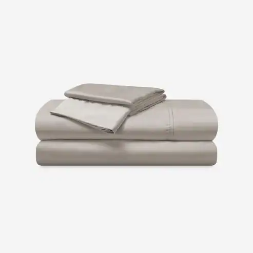 A neatly folded set of light gray Hyper - Cotton Performance Sheets, featuring a fitted sheet, flat sheet, and two pillowcases, displayed on a plain white background.