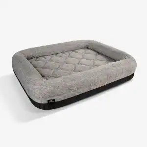 The Performance Dog Bed is rectangular and gray with raised sides and a quilted center cushion, shown on a plain white background.