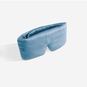 The Hyper Silk Performance Sleep Mask, shown on a plain white background, is blue with padding, a soft curved design, and features an inner pocket.